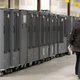 A Georgia Republican Party poll watcher looks over voting machine transporters being stored at the Fulton County Election Preparation Center on November 4, 2020, in Atlanta, Georgia.